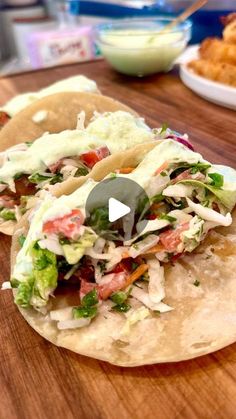 two tacos sitting on top of a wooden table