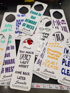 several white door hangers with words on them