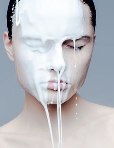 a man with white paint on his face and nose dripping from the top of his head