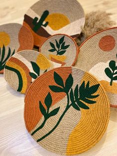 several woven baskets with plants on them sitting on a table next to a stuffed animal