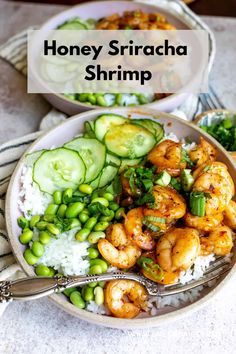 a bowl filled with shrimp, rice and cucumber on top of a table