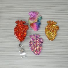 This badge holder is crafted from resin and glitter. The resin piece measures approximately 2 inches in height. You may choose from a reel with a fixed belt clips that slides on or a swiveling reel with a pinch on clip. Each reel is retractable and has a 34 inch nylon cord. Each piece has been hand painted and has been sealed with a protective layer of resin. Making the badge wipable. With hand poured resin there will always the possibility for a tiny air bubble or bump. I do my very best to ens Nursing Aesthetic, Resin Badge Reel, Belt Clips, Resin Badge, Makeup Brushes Guide, Resin Making, Nursing Accessories