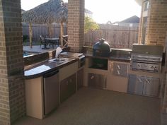 an outdoor kitchen with stainless steel appliances