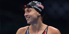 a woman wearing a swim cap with an american flag on it