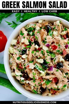 greek salad with chicken and olives in a white bowl