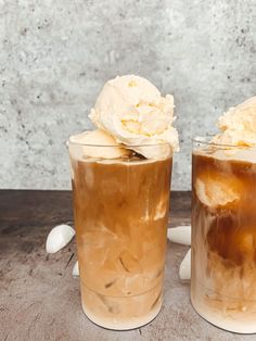 two glasses filled with ice cream sitting next to each other on top of a table