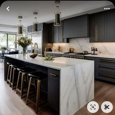 a large kitchen with marble counter tops and black cabinets, along with bar stools