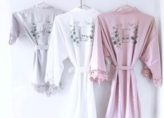 "Introducing our exquisite collection of satin lace robes, designed to enhance your wedding party experience with unmatched elegance and comfort. Crafted with meticulous attention to detail, these robes are available in 12 stunning colors, ensuring a perfect match for your wedding theme or individual preferences. Indulge in the sumptuous feel of high-quality satin, caressing your skin with a gentle touch of luxury. The robe's graceful silhouette and intricate lace accents add a touch of feminini Lace Robes, Satin Pyjamas, Bridesmaid Satin, Satin Robes, Robe Wedding, Wedding Clothing, Bridal Robe, Wedding Robe, Eucalyptus Wreath