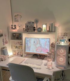 a desk with a computer, keyboard and mouse on it in a room filled with stuffed animals