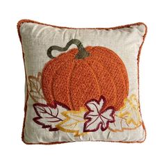 a decorative pillow with an orange pumpkin on it