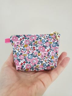 "100% Cotton. Lightweight. From the world famous Liberty Fabrics with a silk-like touch, unique print quality and striking color vibrancy. This mini pouch is great size for a couple of small items. Size is 4\"W / 3\"H / 1.5\"D (10cm / 8cm / 3.5cm) Flat bottom shape. Fabric is Liberty of London Tana Lawn. The pouch opens with golden color zipper.(High quality YKK zipper) It comes with a velvet ribbon on one side.(color is pink) Lined inside with pretty baby-pink color cotton. Please, Hand wash. O Cute Multicolor Cosmetic Bag With Zipper Pouch, Cute Multicolor Cosmetic Bag As Gift, Cute Multicolor Cosmetic Bag Gift, Cute Multicolor Cosmetic Bag With Removable Pouch, Cute Multicolor Pouch With Removable Pouch, Pink Fabric Bag As A Gift, Pink Fabric Bag As Gift, Pink Fabric Bag For Gift, Multicolor Cosmetic Bag With Zipper Closure As Gift