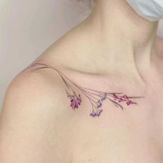 a woman's chest with purple flowers on it