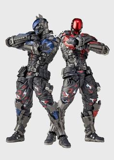 two men in futuristic suits standing next to each other with their hands on their hipss