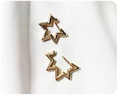 "✷ 5-Pointed Star Hoop Earrings * 18k gold plated ✷  A pair of modern hoops featuring bold star-shaped design in gold for a playful touch to your look. Open the lever-back hoops by gently pulling them apart at the top, opening via the hinge at the bottom, to reveal the 18-carat gold plated hypoallergenic ear posts. A flirty yet edgy accent to adorn any outfit, theses Star Hoops are a timeless, whimsical gift for those with pierced ears.  About this Piece: * Length: 5/8\" * Width: 11/16\" * 18K G Gold Star-shaped Hoop Earrings For Party, Gold Star Hoop Earrings For Party, Trendy Gold Hoop Earrings With Star Charm, Trendy Gold Earrings With Star Charm, Star Hoop Earrings, Jewelry Ear, Ear Party, Whimsical Gifts, Hoop Earrings Gold