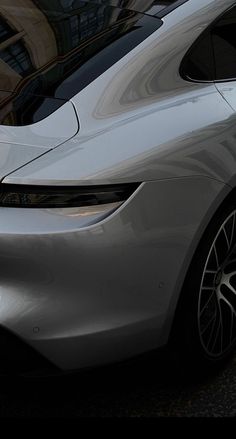 a silver car parked in front of a building