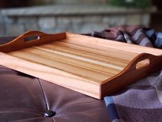 a wooden tray sitting on top of a couch