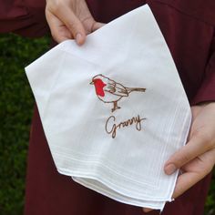 This gorgeous handkerchief is beautifully embroidered with a stunning robin in red and black thread, making for a personalised and practical gift. A beautiful hanky with a delicately embroidered robin accompanied by a name embroidered underneath in brown thread. A gorgeous gift for Granny or a Christmas gift for her as a keepsake as well as a practical gift that we know she will cherish forever. The robin has been drawn by our wonderful creative team, with the design taking a simple hanky and creating a gorgeous personalised gift for Grandma or Mum this on their birthday. Dimensions: Approx 36cm Square Made from: 65% polyester, 35% cotton with embroidery In Memory Of Gifts, Personalized Handkerchiefs, Christmas Robin, Gifts For Nan, Grandmas Christmas, Robin Bird, Grandma Birthday, Gift For Grandma, Bird Lover