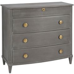 a grey chest of drawers with gold knobs