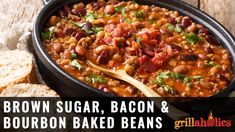 brown sugar, bacon and bourbon baked beans in a skillet with bread on the side