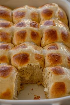 a casserole dish filled with rolls and cheese