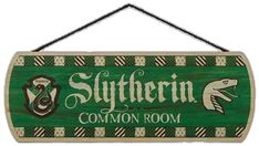 a wooden sign hanging from the side of a wall that says slyferin common room