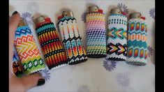 four lighters are decorated with multicolored knitted fabric and silver caps,