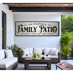 a living room with couches and tables in front of a large sign that says the graveyard's family patio