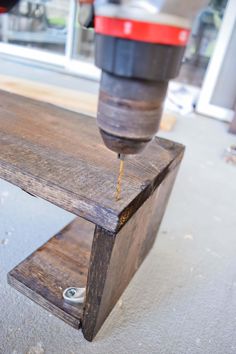 a drill is being used on a wooden bench