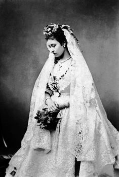 an old black and white photo of a bride