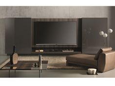 a living room with furniture and a flat screen tv mounted on the side of it