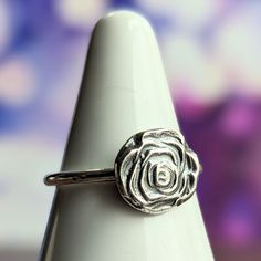 "These are so fun! I made the rose by melting scrap silver (making it into a large molten ball, \"shot\") and hammering it in a shot plate. Similar to using a die and a hydraulic press, but more tired muscles! 😂    The sterling silver band is 14 gauge. Listing is for the exact ring shown, size 7.  All components are sterling silver. Lovestruck Soul - a one woman in-home jewelry studio, creating hand fabricated jewelry one piece at a time with love, a hammer, and a torch." Sterling Silver Rose Design Flower Ring, Adjustable Sterling Silver Flower Ring With Rose Design, Adjustable Sterling Silver Rose Design Ring, Molten Ball, Plate Jewelry, Silver Rose Ring, Hydraulic Press, Recycled Gifts, Floral Hoops