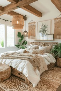 a large bed sitting in a bedroom next to a window with potted plants on it