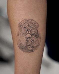 a lion and cub tattoo on the leg