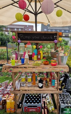 an outdoor stand with drinks and condiments on it