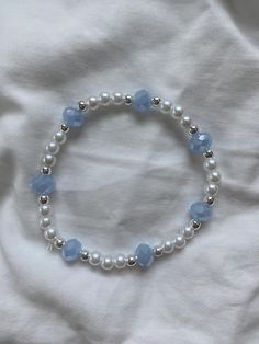 Pearl with light blue and silver accents, this beautiful bracelet makes for the perfect accessory for going out Blue And Silver Aesthetic, Light Blue Jewelry, Light Blue Bracelet, Silver Pearl Bracelet, Manik Manik, Aesthetic Accessories, Wrist Stacks, Bracelets Ideas, Diy Jewlery