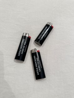 three batteries sitting on top of a white sheet