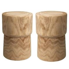 two wooden stools sitting next to each other