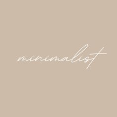 the word minimalist written in white ink on a beige background