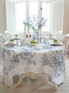 the table is set with blue and white flowers