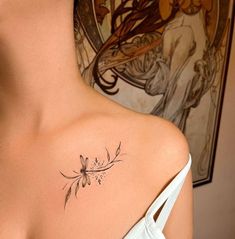 a woman with a flower tattoo on her shoulder