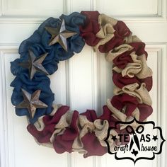 a patriotic wreath hanging on the front door