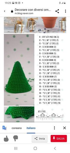 a green crocheted christmas tree sitting on top of a table next to a potted plant