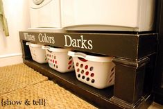 three white laundry baskets sitting on top of a shelf next to a washer and dryer