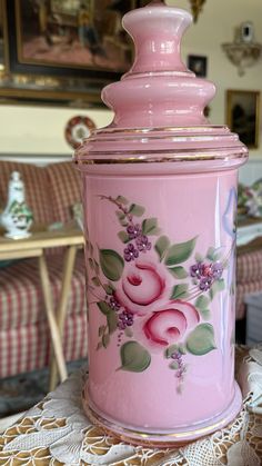 a pink canister sitting on top of a table