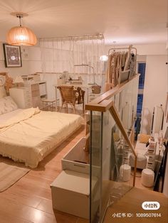 a bed sitting on top of a hard wood floor next to a glass case in a bedroom