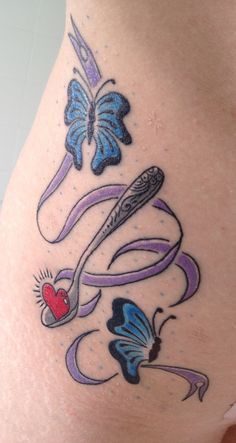 a woman's thigh with tattoos and butterflies on it