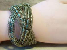 Beaded cuff bracelet. It measures approx. 1-1/2 inch thick and is flexible and should fit most size wrists. Made with small gold seed beads. It has a woven design. Add it to your jewelry wardrobe. Pre owned in great condition. All sales are final and as is. Thank you for looking. You may also love this: https://www.etsy.com/listing/510068528/brown-bronze-beaded-cuff-bracelet-woven?ref=shop_home_active_3 Bohemian Gold Cuff Bracelet With Round Beads, Gold Bohemian Cuff Bracelet With Round Beads, Gold Beaded Metal Wrap Bracelet, Gold Beaded Cuff Bracelet With Round Beads, Bohemian Gold Metal Wrap Bracelet, Gold Metal Bohemian Wrap Bracelet, Bohemian Gold Beaded Nickel-free Bracelets, Gold Beaded Cuff Bracelet, Bohemian Beaded Bracelets With Gold And Silver Beads