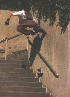 a man on a skateboard doing a trick down some stairs