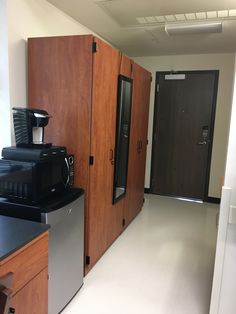 a coffee machine sitting on top of a counter next to a refrigerator