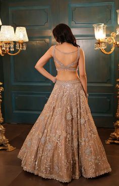 This gold lehenga features hand embroidered 3D flowers throughout along with sequin,crystal, pearl and cutdana embroidery. It is paired with a matching embroidered V neck blouse detailing,and an embroidered dupatta.From Isa by Dolly Wahal's Fiori collection.DELIVERY TIMEPlease allow 8-12 weeks for your outfit to arrive.FABRIC DETAILSNetProfessional cleaning only. Cocktail Lehenga, Lehenga Bride, Indian Lengha, Cutdana Embroidery, Gold Lehenga, Embroidered Dupatta, 3d Flowers, 12 Weeks, Color Chrome